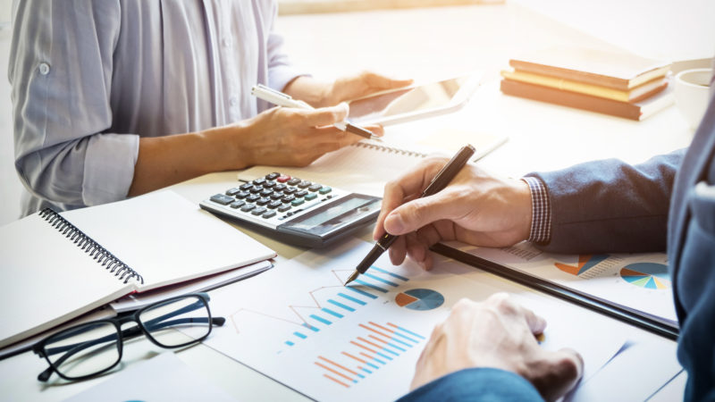 business man financial inspector and secretary making report, calculating or checking balance. Internal Revenue Service inspector checking document. Audit concept business man financial inspector and secretary making report, ca